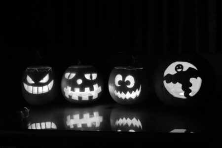 Four pumpkins carved by our family