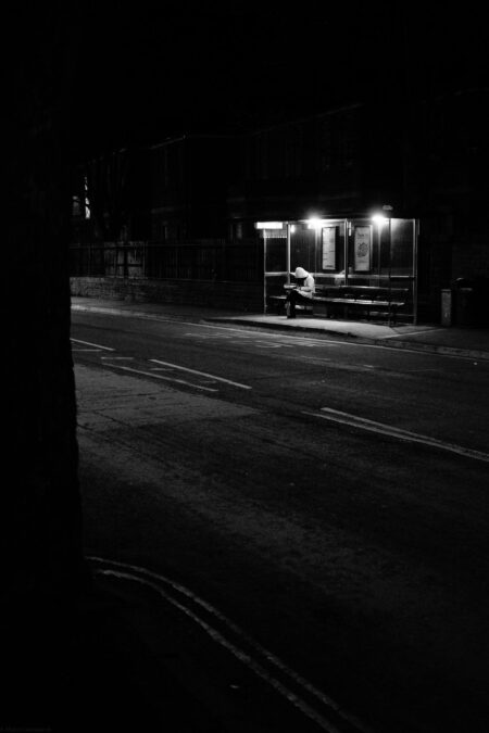 Hooded women waiting at a bus stop near Southmead hospital