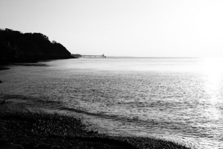 Clevedon pier seen from a distance on a beach in the north