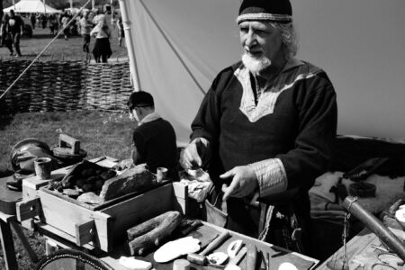 Silversmith explaining his craft at a medieval fair in Glastonbury